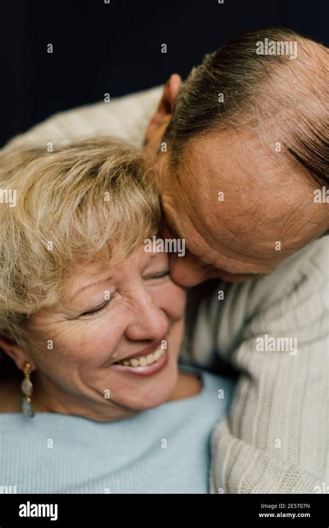 Portrait Of Old Couple Wife And Husband Hugging And Smiling Dark Blue Background Happy Lovers