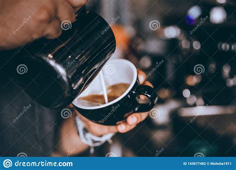 Professional Barista Pouring Steamed Milk Making Coffee Latte Art In