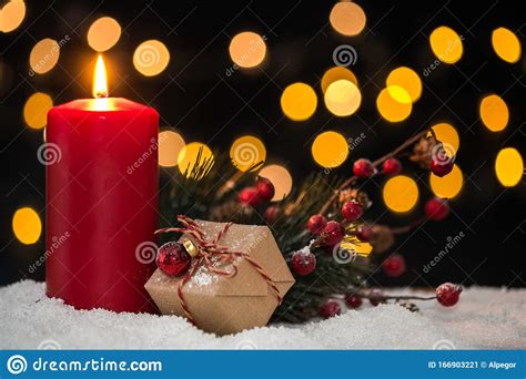Chistmas Candle On Snow With Lights In Background Stock Image Image