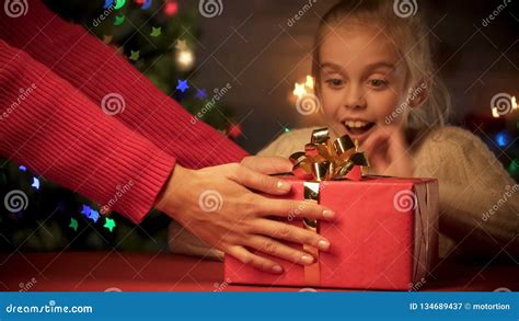 mother giving christmas t to excited daughter holidays delivery service stock image image