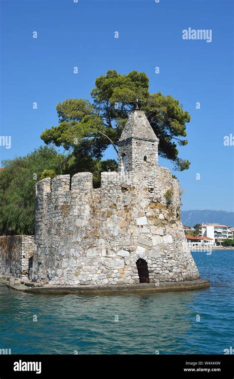 The Old Venetian Lighthouse In Ports Entrance Of Nafpaktos Stock Photo
