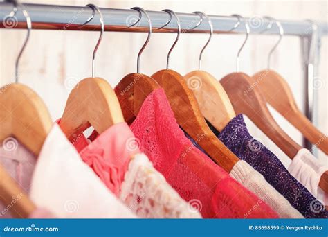 Pink Womens Clothes On Hangers On Rack In Fashion Store Closet Stock
