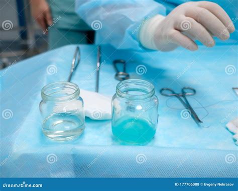Sterile Surgical Instruments And Glass Containers With Solutions On The