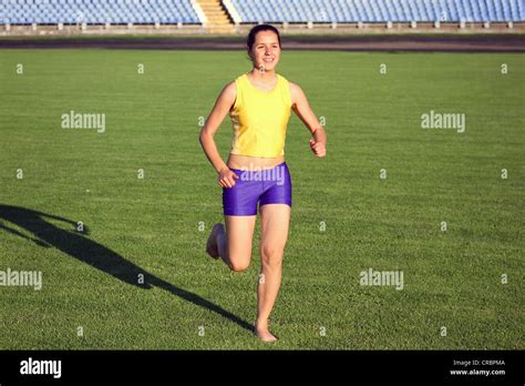 Beautiful Teenage Sport Girl Running On The Grass Active Hi Res Stock