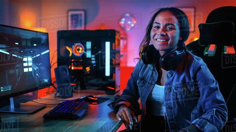Portrait Of A Pretty And Excited Black Gamer Girl In Headphones Who