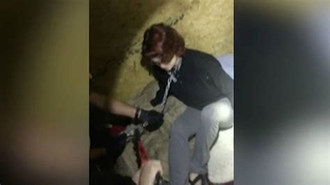 shocking video shows the moment police rescued a woman held prisoner for months by serial killer
