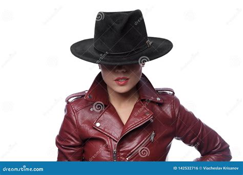 Brunette Woman Wears A Black Hat And A Leather Jacket Stock Photo
