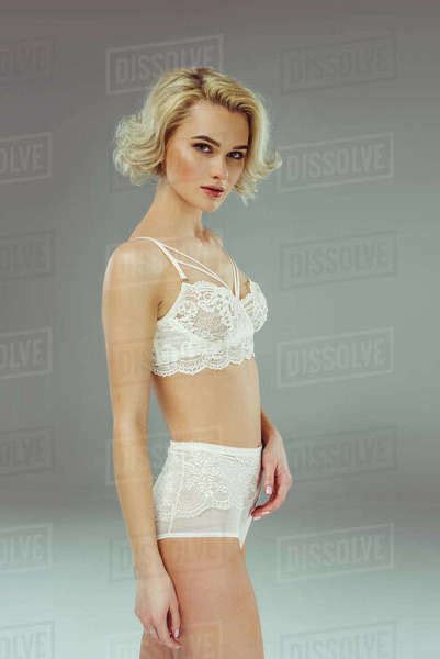 Sexy Woman Posing In White Lace Lingerie Isolated On Grey Stock Photo Dissolve