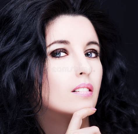 Young Attractive Woman With Long Black Hair On Dark Background Stock