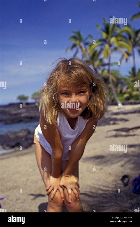 A Cute Smiling Young Girl Strikes A Pose On A Beach At The Kona Village