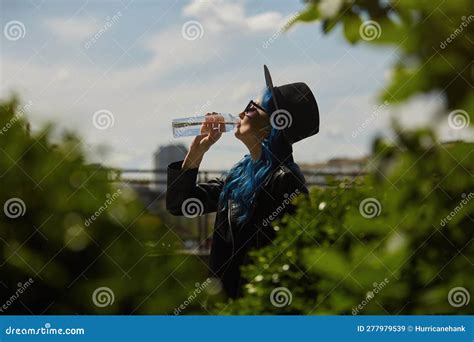 Diverse Female Model Drinking Water From A Reusable Glass Bottle In The
