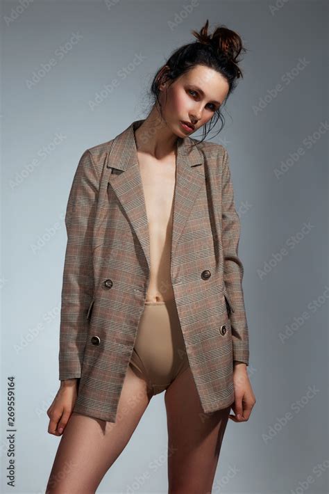 Cute Brunette Woman Wearing A Jacket Over Her Naked Body And High Waisted Underwear Posing In