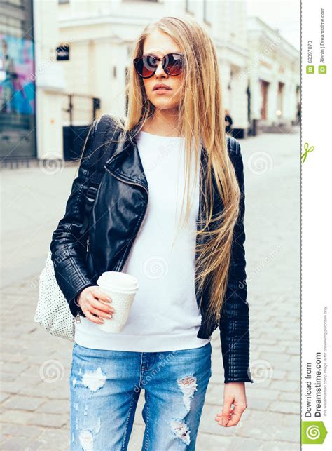 Portrait Of A Young Beautiful Blonde Girl With Sunglasses Walking On