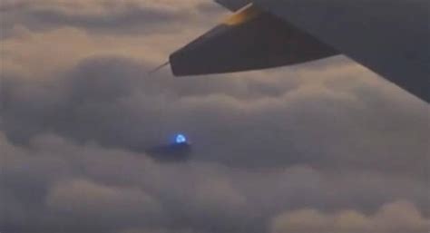 airplane passenger captures strange blue light in the clouds video