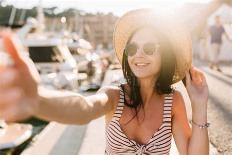 Laughing Girl With Tanned Skin Making Selfie While Sunbathing In