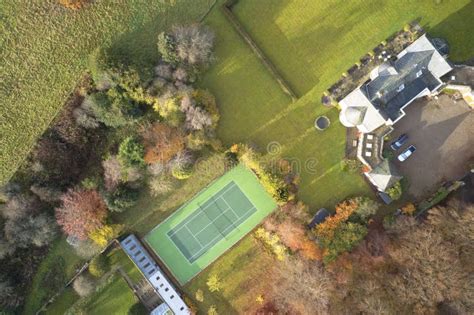 Mansion And Private Tennis Court In Real Estate Grounds Aerial View