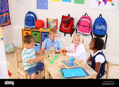 Four Kids Playing In Preschool Classroom Stock Photo Alamy