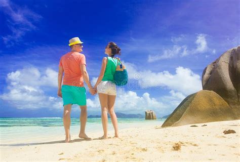 Young Couple Relaxing At Beach With Granite Rocks Anse Source D Argent