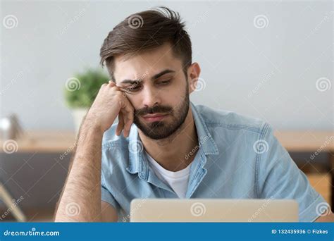 Lazy Man Feel Unmotivated Sitting Near Laptop At Home Stock Photo