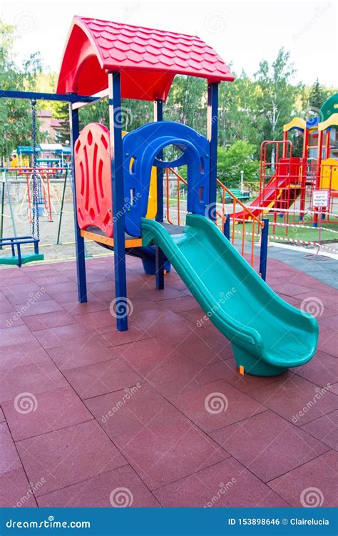 Colorful Children S Playground With Slides And Swings Outdoors In The