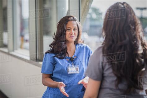 Nurses Talking In Hospital Hallway Stock Photo Dissolve