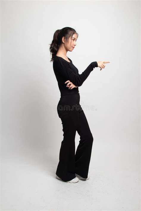 Full Body Side View Of Beautiful Young Asian Woman Pointing Stock Image