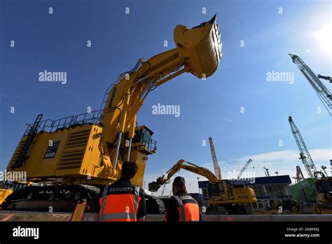 A Giant Excavator Stands On The Grounds Of The Construction Machinery