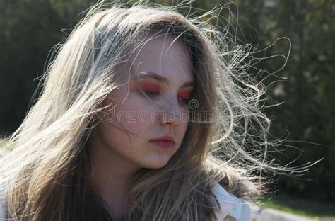 Portrait Of Young Girl Close Up Portrait Of A Young Woman With Her Hair Blowing In The Wind