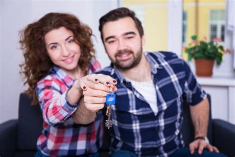 Real Estate Concept Happy Smiling Young Couple Showing Keys Of Stock