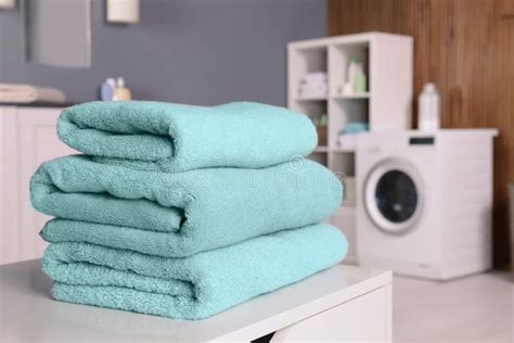 Stack Of Clean Towels On Table In Laundry Room Stock Photo Image Of