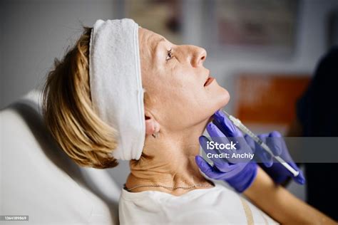 Female Doctor Giving Patient Lipolysis Double Chin Treatment Stock