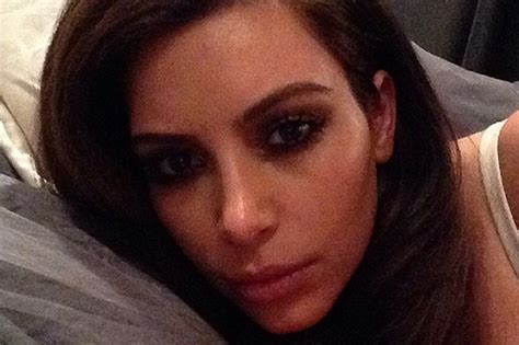 kim kardashian shows in bed selfie with brunette locks as she lies in bed and tells us she s