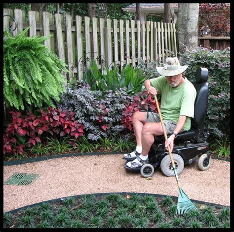 A Man Sitting In A Wheel Chair With A Broom On The Ground Next To Some
