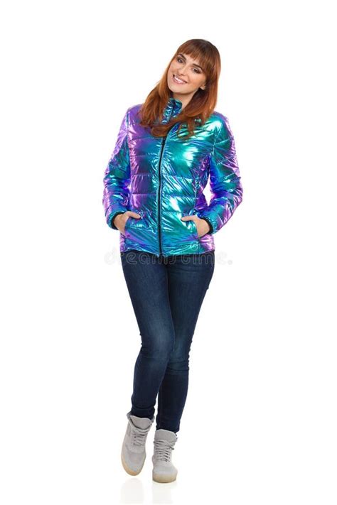 Smiling Young Woman In Vibrant Down Jacket Is Holding Hands In P Stock