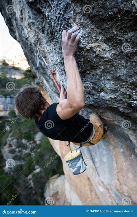 Rock Climber Ascending A Challenging Cliff Extreme Sport Climbing