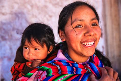 Peruvian Woman With Her Baby On The Back Pisac Stock Photo Download