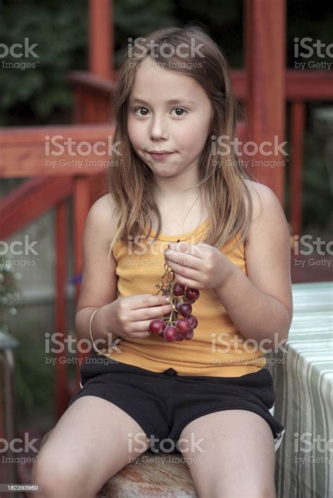 Little Girl Eating Grapes Stock Photo - Download Image Now - iStock