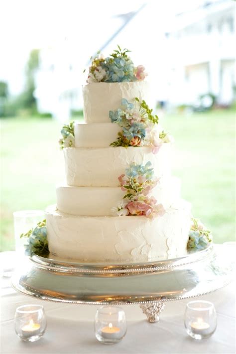 This was a very simple butter cream cake that was decorated with flowers all along one side. Pastel Wedding Cake with Flowers