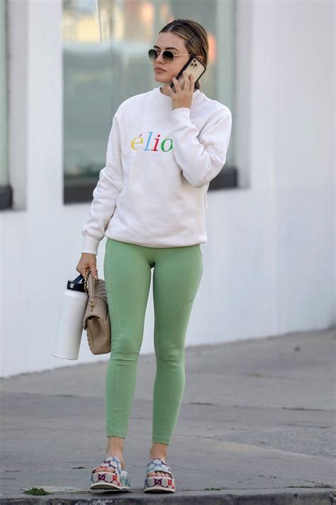 Lucy Hale Sports A White Sweatshirt And Green Leggings As She Attends A