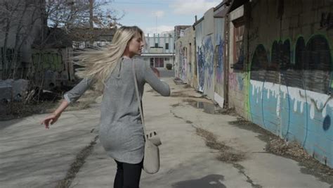 Medium Slow Motion Tracking Shot Of Woman Running Away In Alley Stock Video Footage Dissolve