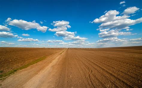 Field And Dirt Road At Spring Sky With Clouds Stock Photo Image Of
