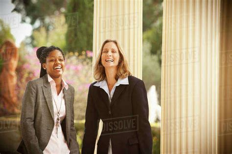 Businesswomen Laughing Together Outdoors Stock Photo Dissolve