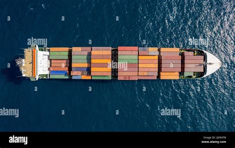Drone Top View Of Fully Loaded Container Ship Cruising Open Ocean Sea