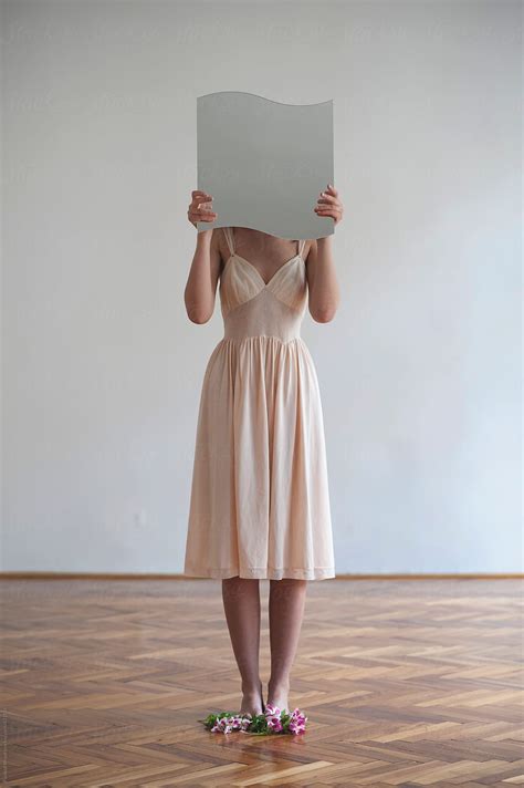 Girl In A Beautiful Dress Hiding Her Face With A Mirror By Stocksy