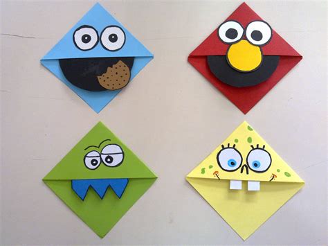 Four Different Colored Origami Envelopes With Eyes And Nose Designs On
