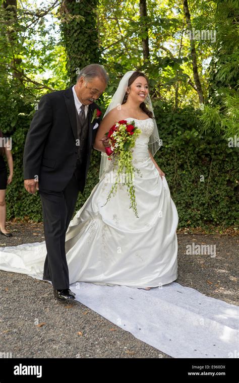 Father Walking His Daughter Down The Aisle During Wedding Ceremony At Marin Art And Garden