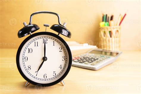 7 AM Clock on work desk in the office Time of business working concepts