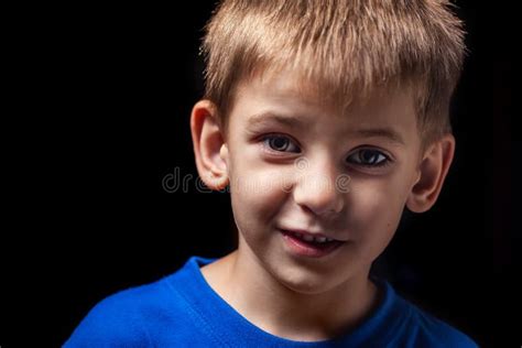 Portrait Of The Boy S Smiling Child Close Up Against A Black