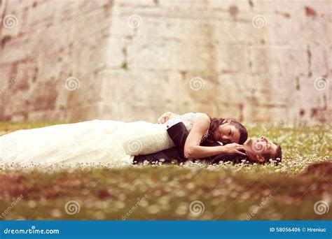 Bride And Groom Laying On Grass Stock Photo Image Of Beautiful