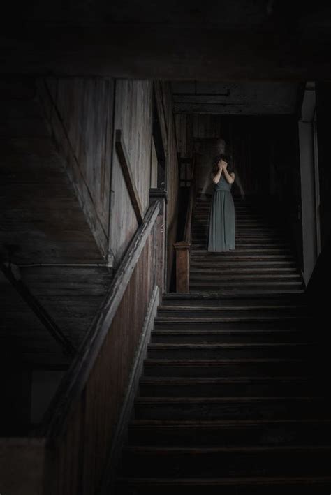 A Woman In A Long Dress Walking Down Some Stairs With Her Hands On Her Hips
